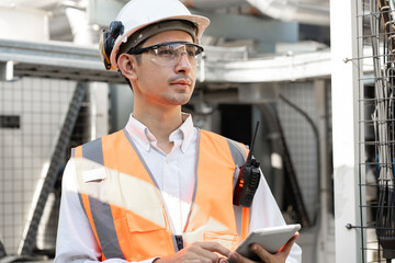 Asia Man engineer using walkie talkie working at rooftop building construction or working checking...