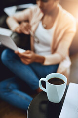 Person, reading and relax in home with coffee and paperwork to review investment in report. Wealth, savings or woman with plan for future, income and learning from bills, taxes or research info