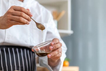 chef make tortilla wrap vegetable salad slice by knife on cutting board and mix sour salad dressing in small bowl glass with wine and olive oil. tortillas wrap vegetable and juicy liquid sour dressing