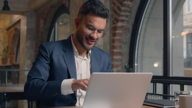 Indian male businessman guy manager freelancer at office finish project end working day accomplish close laptop free happy relaxed business man put hands behind head lean on chair relax cheerful smile