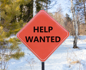 Help wanted and support symbol. Concept words Help wanted on beautiful red road sign. Beautiful forest snow blue sky background. Business, support, help wanted concept. Copy space.