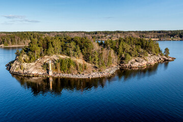 Marine signs and lighthouse in the Stockholm archipelago rocky island to help you navigate in...