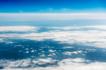 White cumulus clouds on clear blue sky background closeup, overcast skies backdrop, fluffy cloud...