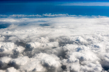 White cumulus clouds on clear blue sky background closeup, overcast skies backdrop, fluffy cloud...