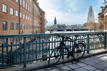 View of Stockholm City Hall and Stream's castle from Stallbron Bridge, with a bicycle docked by the...