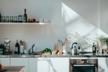 Minimalist kitchen with stainless steel appliances and a healthy post-workout snack on the counter,...