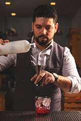 Expert bartender pouring a cocktail