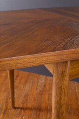 Vintage dining table with extraordinary grain pattern. 1950s Midcentury Modern walnut furniture. Close-up detail photograph.