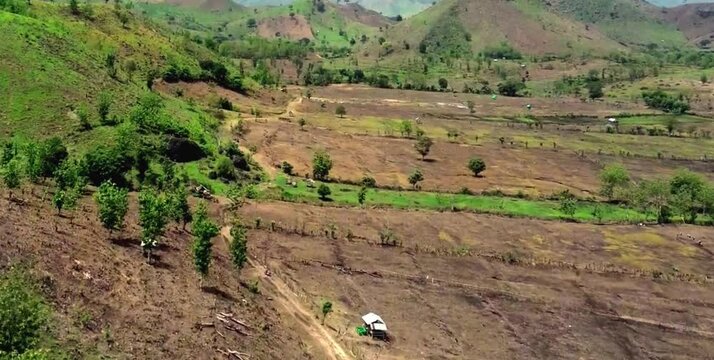aerial video of deforested forests in mountainous areas being converted into agricultural land