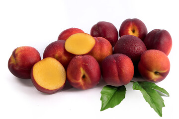A dozen juicy ripe nectarines coated with water droplets isolated on a white background - obrazy, fototapety, plakaty