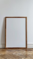 Empty picture frame on a white wall in a room with wooden floor