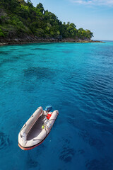 Real tropical green island photo and rubber boat float in shallow turquoise sea water color with...