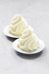 Lemon cream dessert, Panna Cotta in the form of Chantilly cream. Light gray background