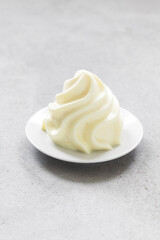 Vegan dessert. Lemon cream dessert, Panna Cotta in the form of Chantilly cream. Light gray background
