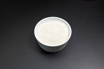 Celtic Gray Sea Salt In Ceramic White Bowl on Dark Table, Horizontal. Natural, Unrefined Salt Harvested From Brittany, France. Natural Minerals, Trace Element, Superfood. Ingredient, Seasoning
