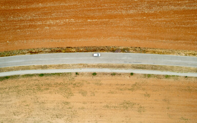 Top view of car driving on rural road.