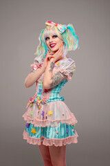 Pretty female clown model in colorful outfit and hair
