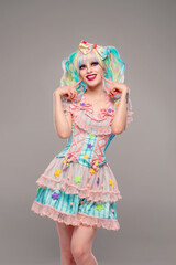 Pretty female clown model in colorful outfit and hair