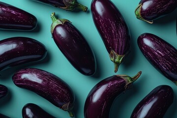 Vibrant eggplants on teal background