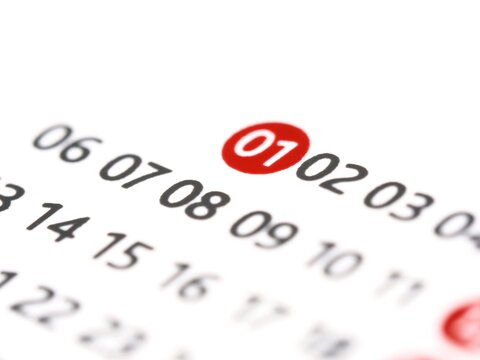 White paper calendar with the number 1 one in a red circle. The first 1st day of the month on a calendar