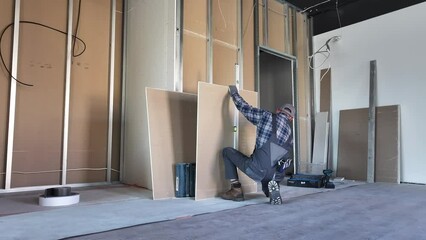 Construction Worker Working on Wall in Room