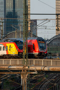 Regional trains from HLB (Hessische Landesbahn) and DB (Deutsche Bahn) beside each other in the sunlight at Frankfurt Main, main station