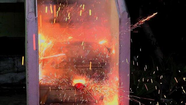 Slow motion effect of a walla fire cracker getting exploded