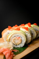 Profile view of salmon, tobiko, Philadelphia, avocado, and shrimp rolls.