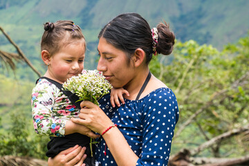 Giving a bouquet of flowers to his mother