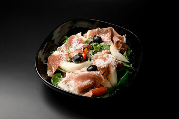 green salad with olives, tuna, and parmesan sprinkles.