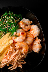 mix salad of peeled shrimp, nori seaweed, sesame seeds, squid, and mango.