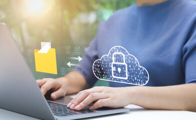 Person Managing Secure Cloud Data Transfer. An individual uses laptop to manage secure data...