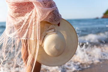 Happy woman walking on beach at sunset.Beautiful female happy relax walking on beach near sea when...