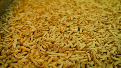 The process of making croutons. Crackers on a conveyor belt. Bakery products on a conveyor line, in a food factory or in a factory with equipment. Bread crackers on a conveyor belt.