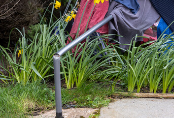 Climate change high winds bend blow down backyard garden rotary clothes drier