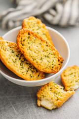 Garlic crisp bread Slices Topped With Herbs in bowl.