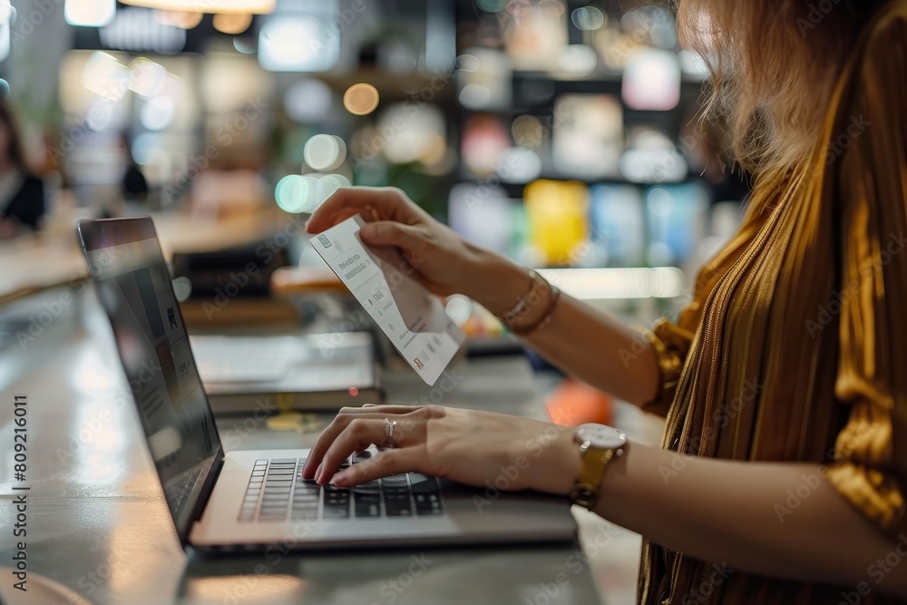 Canvas Prints A woman is seated at a table, actively engaged with a laptop computer, A customer receiving personalized recommendations based on their past purchases