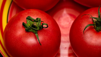 Close up of ripe red tomato, tomatoes background.