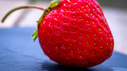 Close up of fresh strawberry showing seeds achenes. Details of a fresh ripe red strawberry.