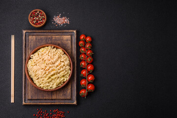 Delicious Asian dish rice noodles or udon with vegetables, spices and herbs