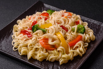 Delicious Asian dish rice noodles or udon with vegetables, spices and herbs