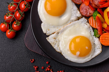 Delicious nutritious breakfast with fried eggs, sausage, steamed vegetables