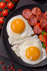 Delicious nutritious breakfast with fried eggs, sausage, steamed vegetables