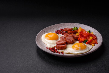 Delicious nutritious breakfast with fried eggs, sausage, steamed vegetables