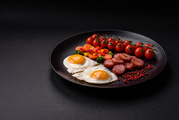 Delicious nutritious breakfast with fried eggs, sausage, steamed vegetables