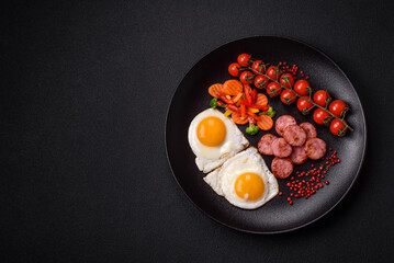 Delicious nutritious breakfast with fried eggs, sausage, steamed vegetables