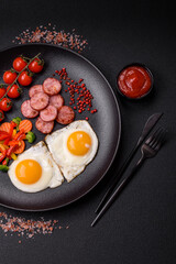 Delicious nutritious breakfast with fried eggs, sausage, steamed vegetables