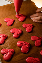 Red hearts on a brown parchment and hands with fair skin