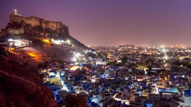 ndia, Rajasthan, Jodhpur, Pachetia Hill, elevated panoramic night view of the illuminated blue city dominated by Fort Mehrangarh