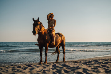 Portrait of a gorgeous woman vacation riding horse on the beach during a dusk